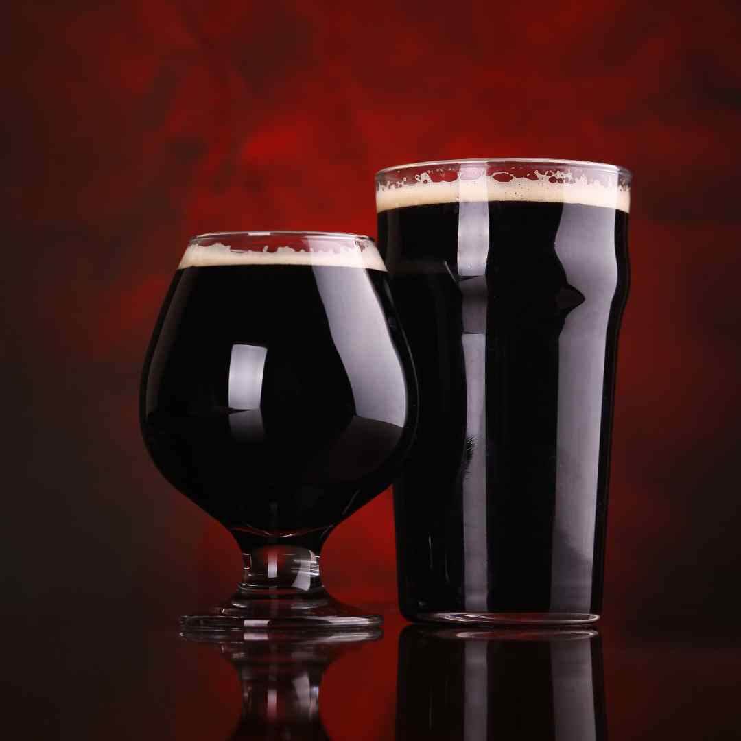 two glasses of dark beer